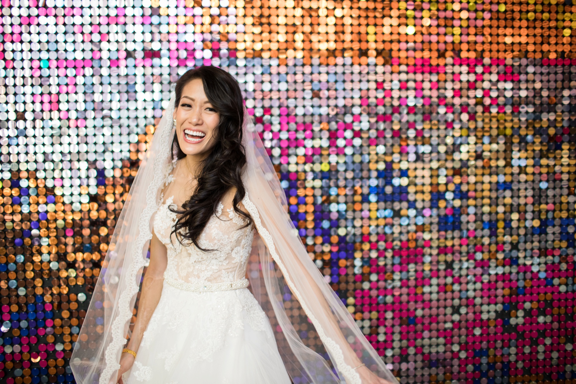 Bride in front of sequin wall at Kimmel Center